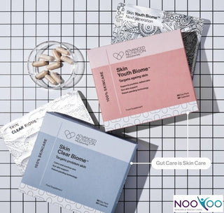 Supplement packages from Advanced Nutrition on a grid background