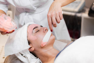 Person receiving a facial treatment with a mask on their face.