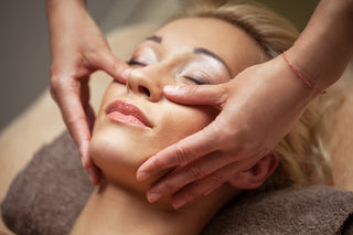 Woman receiving a facial massage in a spa setting